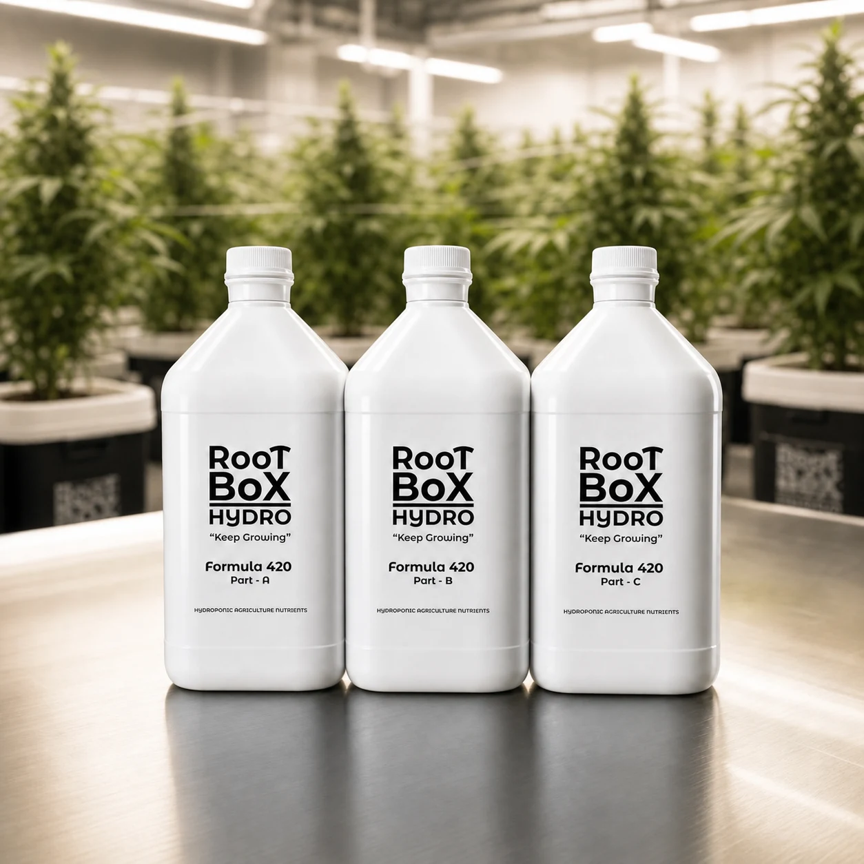 RootBox Hydro Formula 420 Part A, Part B, and Part C 1000 ml bottles on a metal table in a hydroponic growing environment.